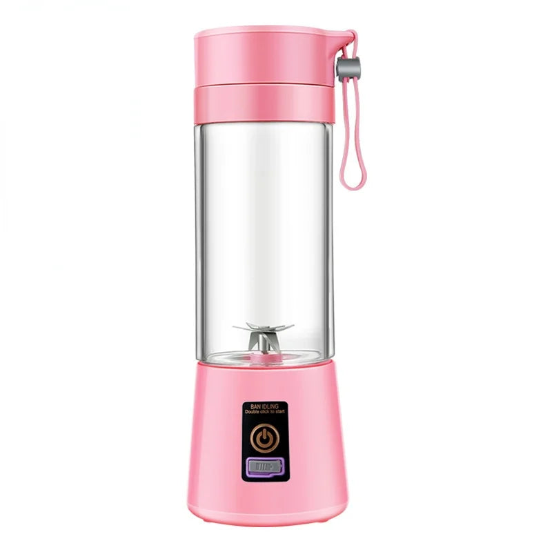 Portable pink personal blender with a clear mixing cup, stainless steel blades, and a power button on the base.