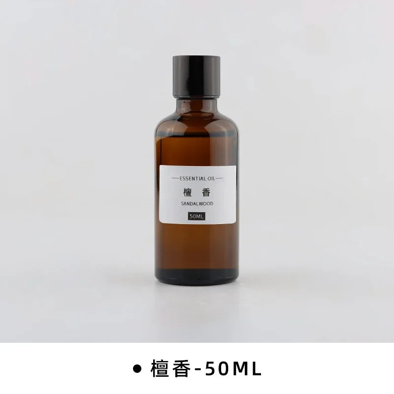 50ml amber glass bottle of Sandalwood essential oil with a black screw cap and minimalist white label.