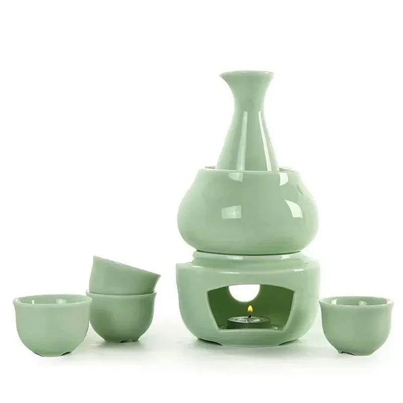 Light green ceramic sake set with bottle, warmer cup, lit candle stove, and four small cups.