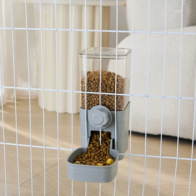 Grey wall-mounted pet food dispenser with a clear container attached to a white wire cage.