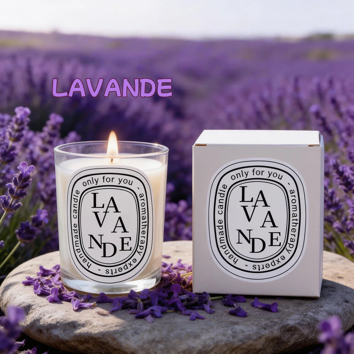 Lit lavender-scented candle in a glass jar with matching box, set on a stone surrounded by lavender flowers.