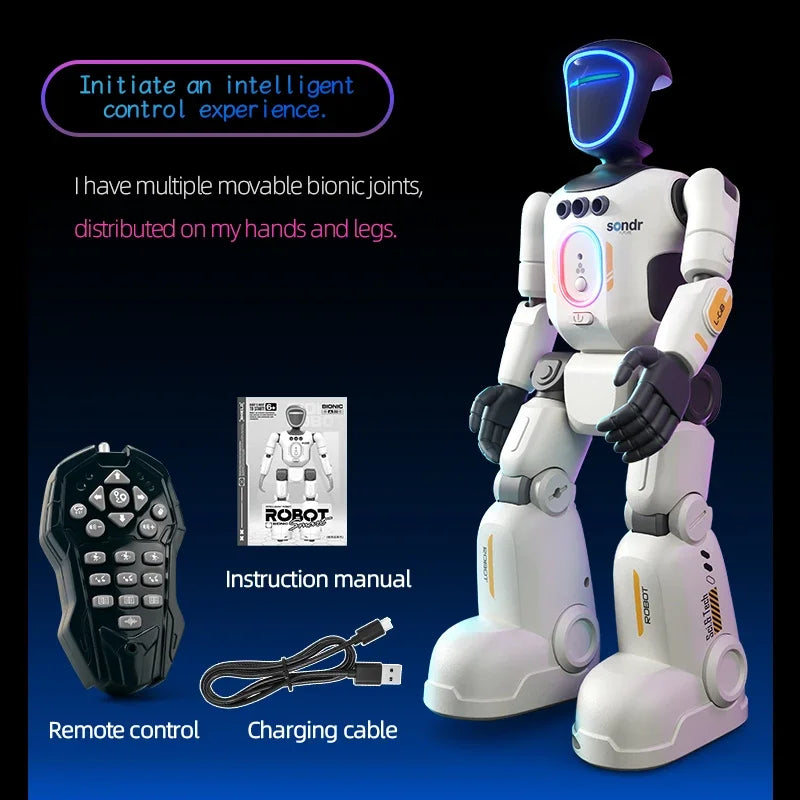 A white and black humanoid robot with a remote control, instruction manual, and charging cable on a blue background.