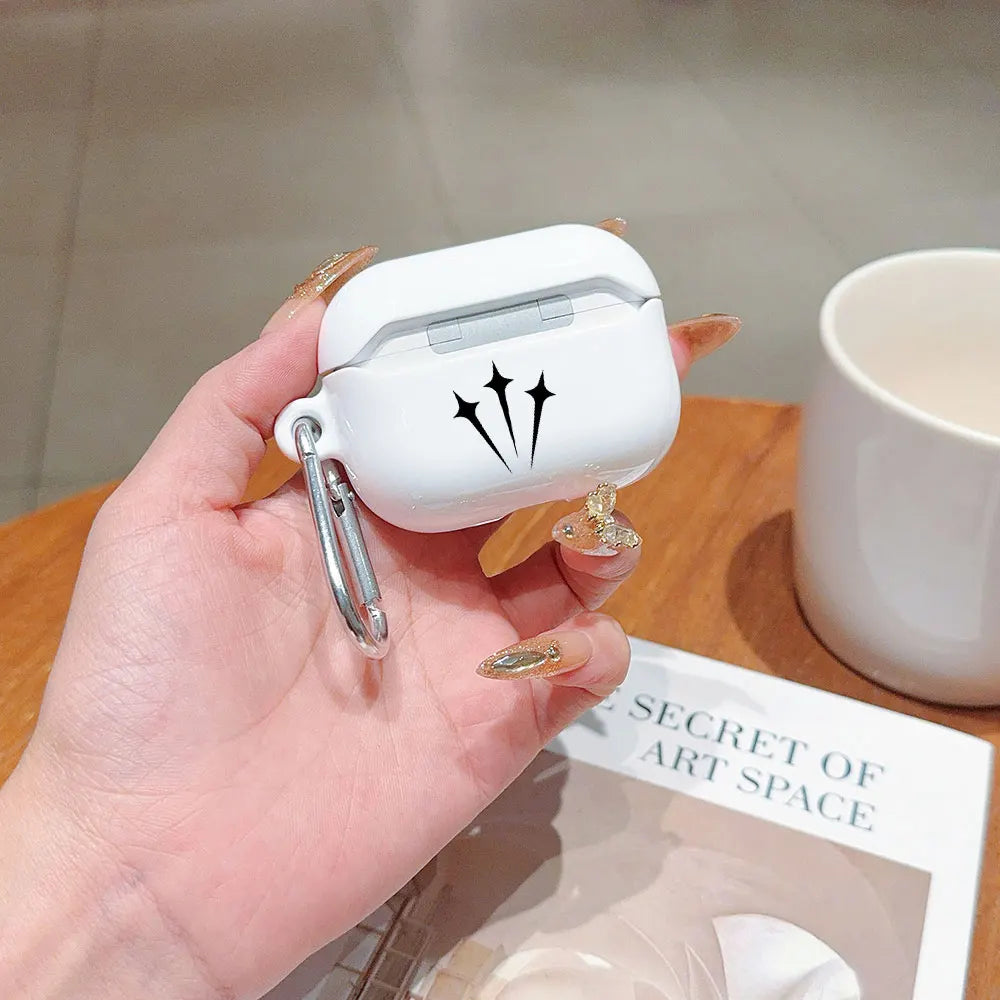 White glossy AirPods Pro case with star design and silver carabiner clip held in hand.