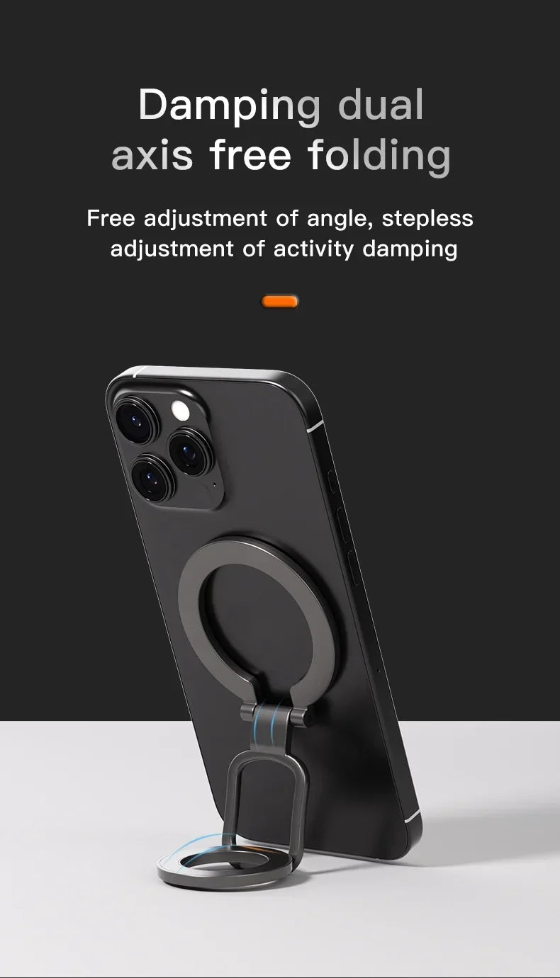 Dark grey, foldable, dual-axis phone ring holder attached to the back of a black smartphone on a white surface.
