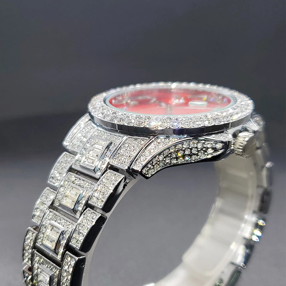 Side view of a silver-tone dress watch with a vibrant red dial and an iced-out, crystal-encrusted case and strap.