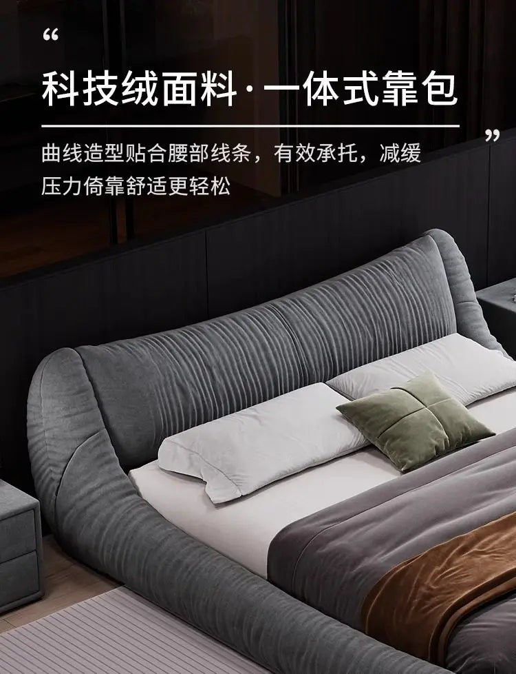 Modern dark grey upholstered bed frame with a textured, curved headboard for ergonomic support.