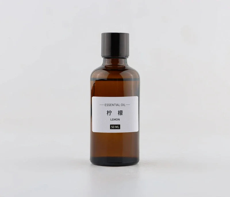 50ml bottle of lemon essential oil in a brown glass dropper bottle with a simple white minimalist label.