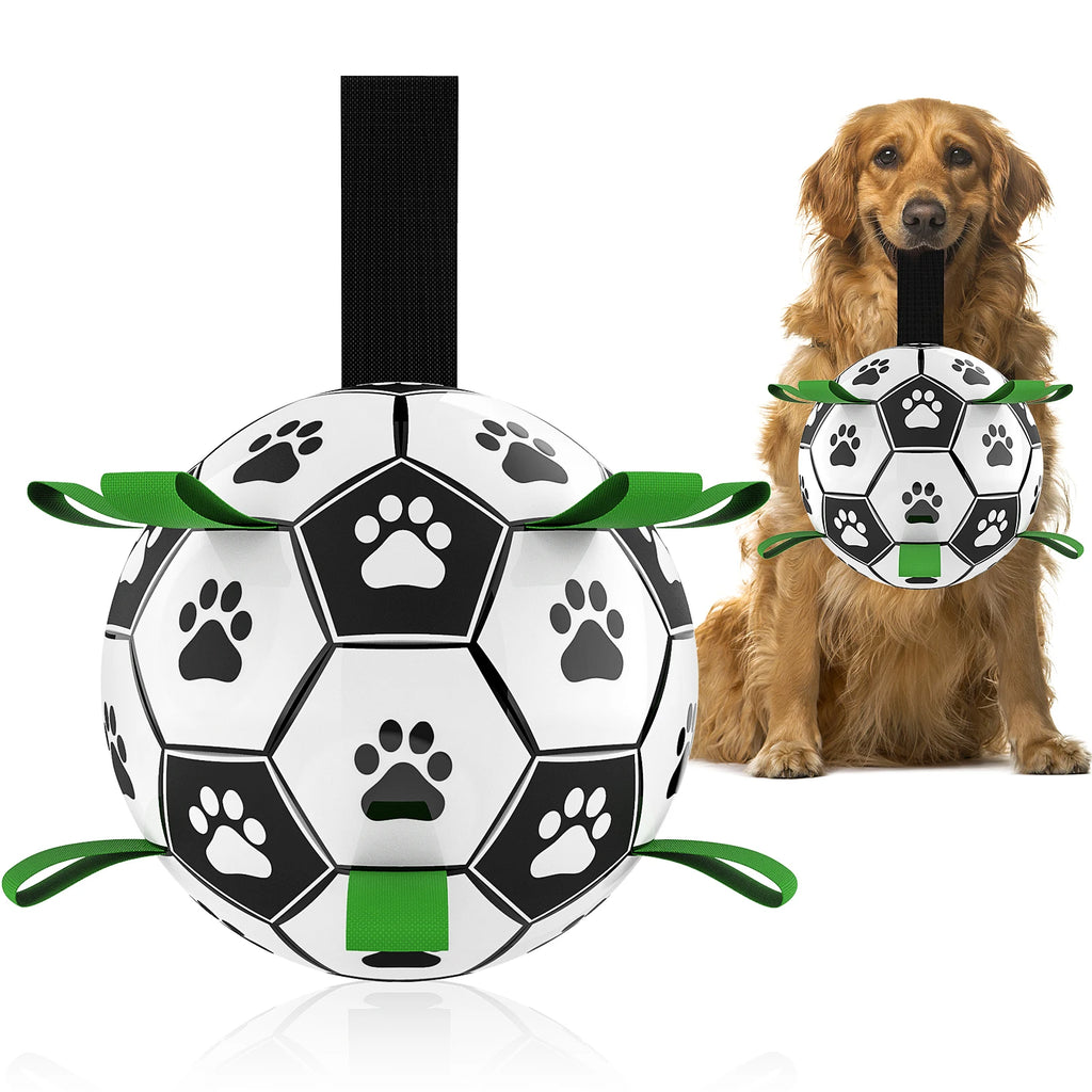 Black and white dog soccer ball with green grab tabs and paw print details, shown being held by a Golden Retriever.