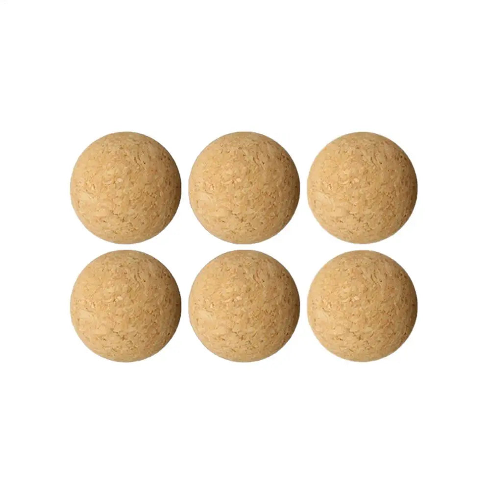Set of six round, natural light brown cork balls with a textured finish on a white background.
