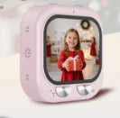 Light pink digital camera for kids with a plastic body, square screen, and two silver control buttons.