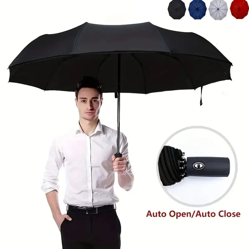 Man holding a large, black, double-layer folding umbrella with auto open-close button.