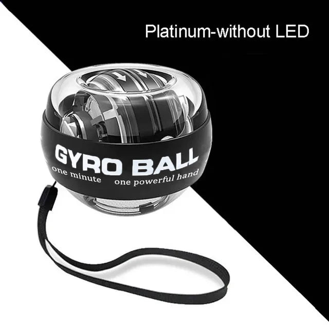 A black and clear platinum Gyro Ball wrist exerciser with a black wrist strap, shown against a split black background.