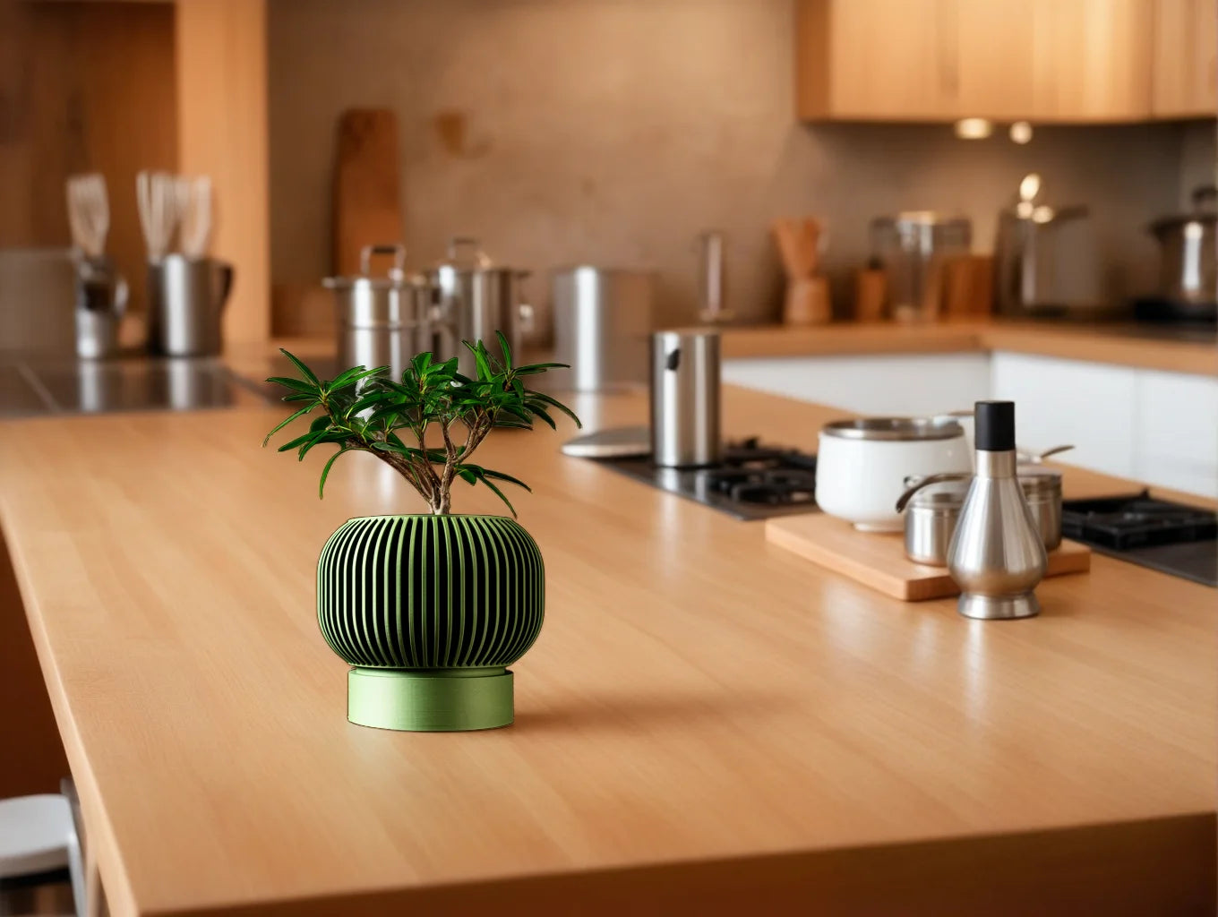 A small, ribbed green 3D-printed plant pot with a bonsai tree sits on a wooden kitchen counter.
