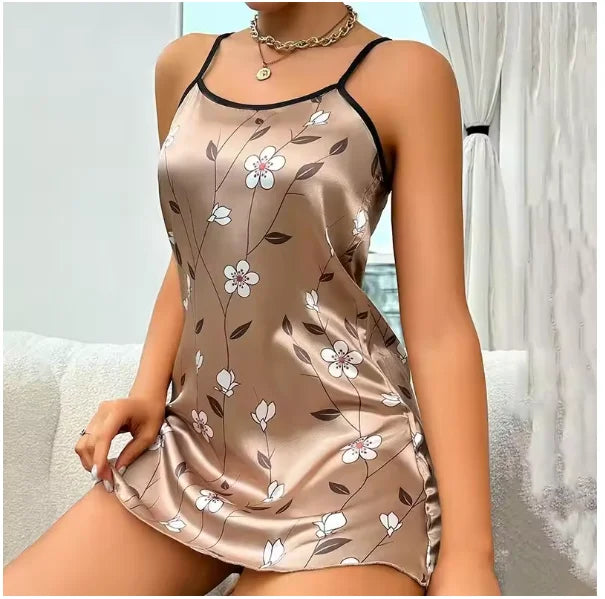 Champagne satin camisole nightdress with black spaghetti straps and a white floral print.