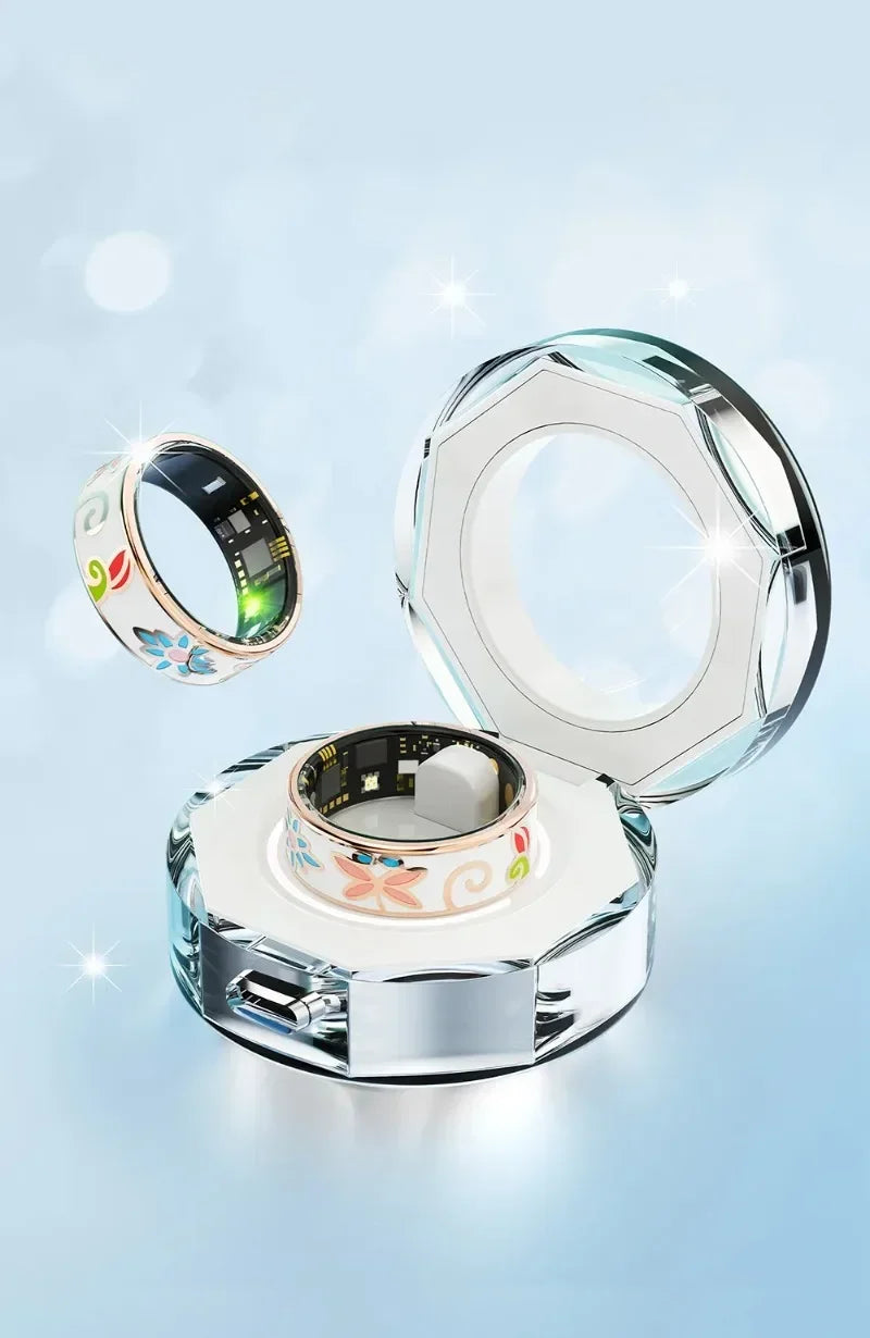 White smart fitness ring with colourful floral pattern and rose-gold trim, displayed with a clear charging case.