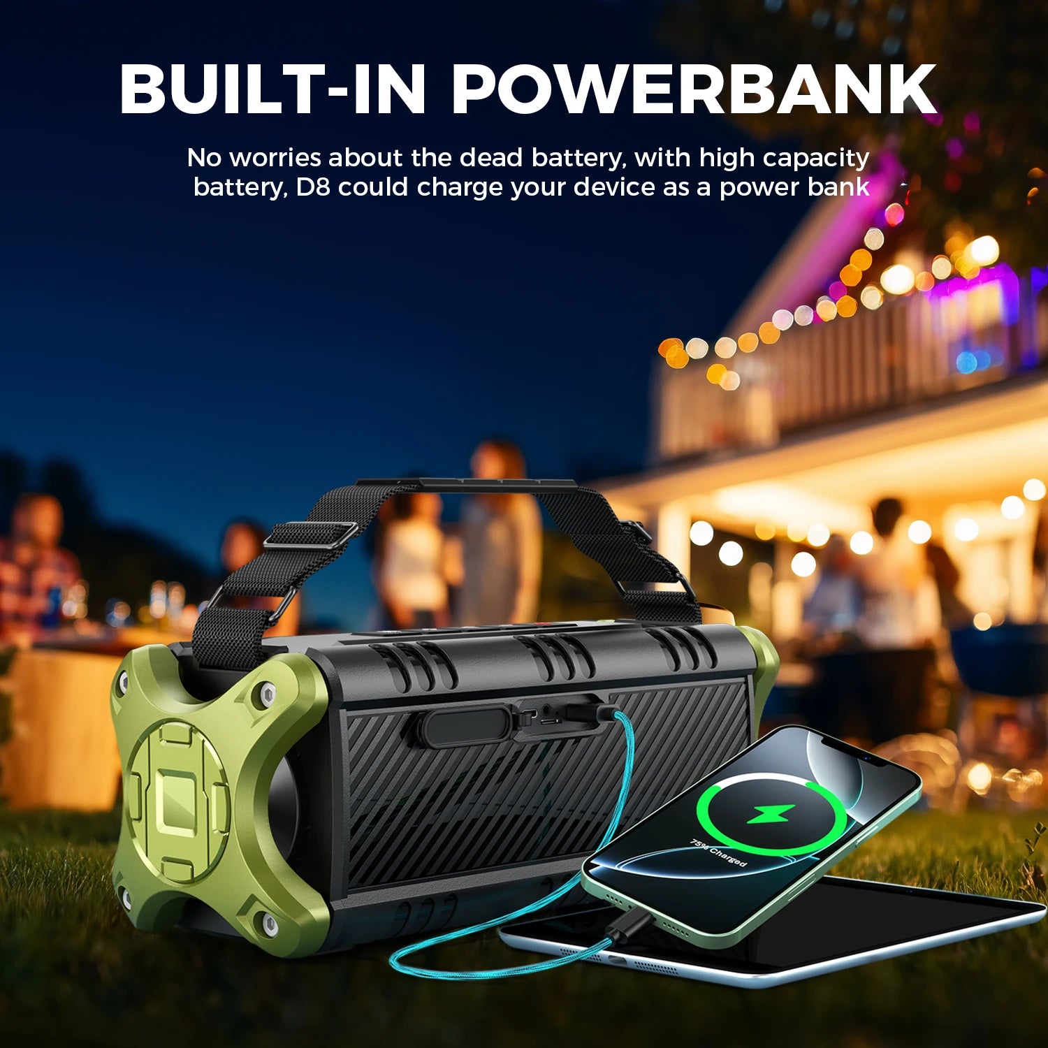 Black and olive green portable wireless speaker with a carry strap, charging a smartphone outdoors at night.