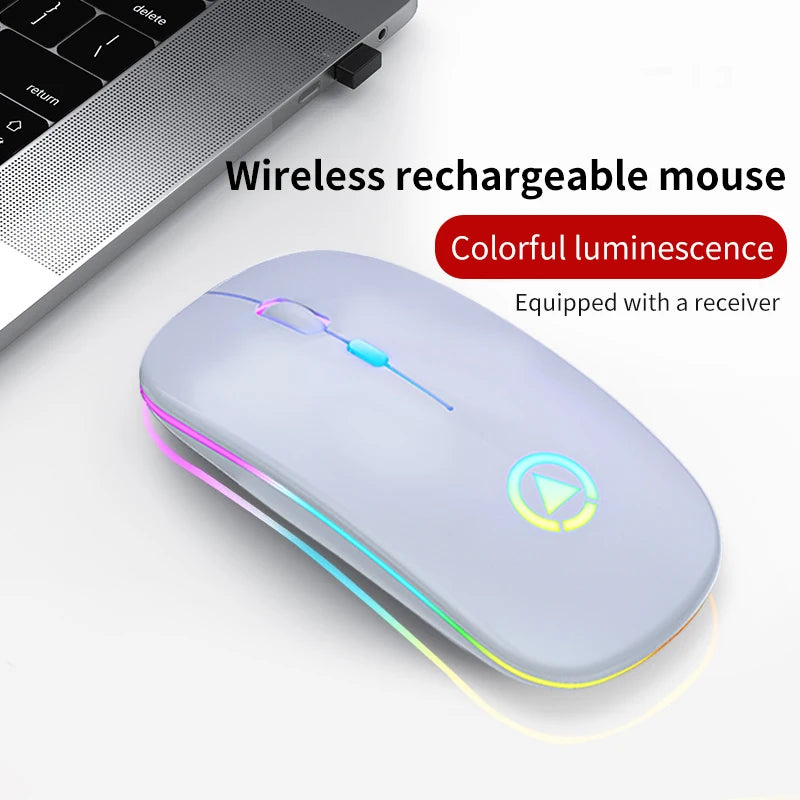 Slim, light grey ergonomic wireless mouse with colourful LED lighting, next to a laptop with a USB receiver.