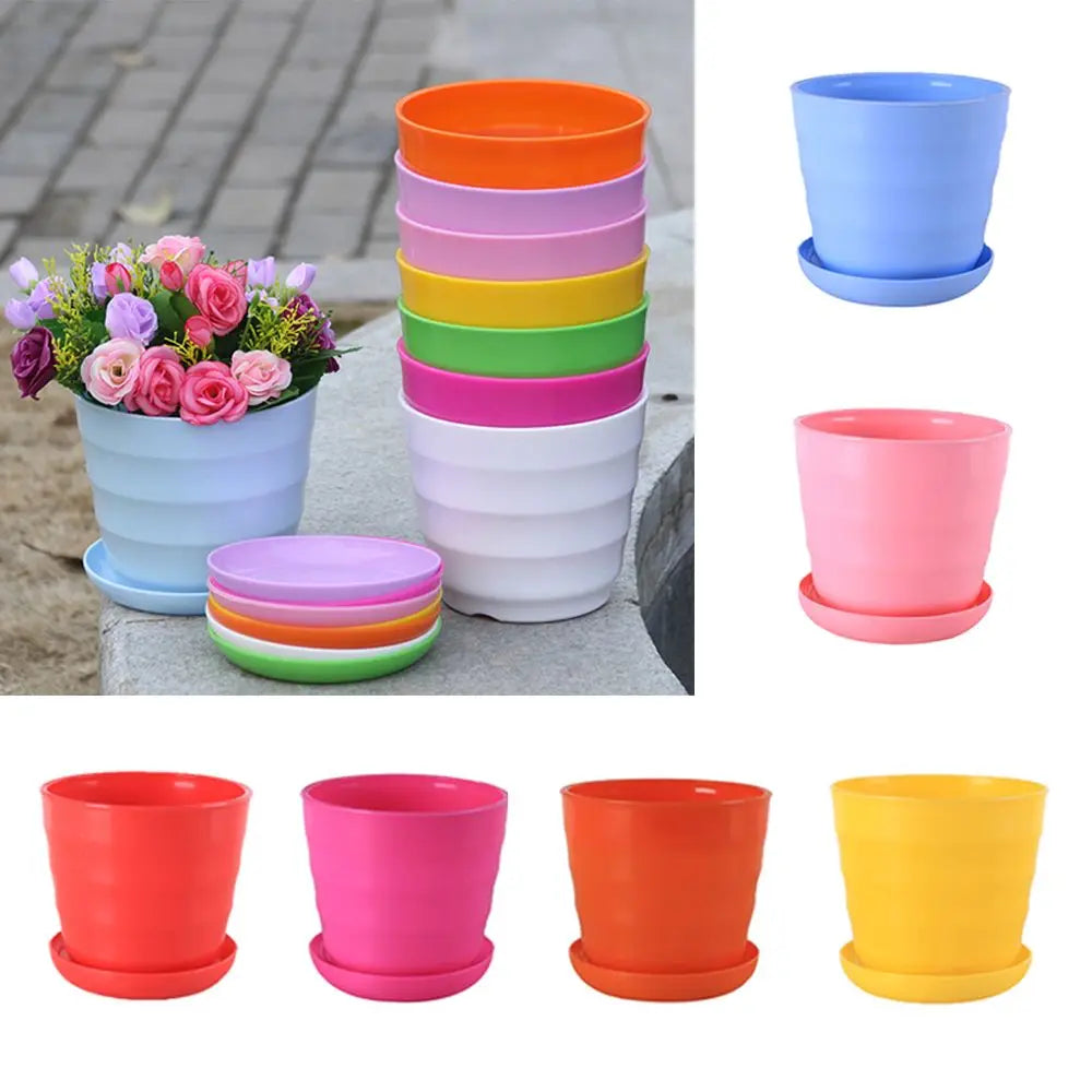 Stack of colorful, ribbed plastic flower pots with matching saucers, featuring a pot filled with artificial flowers.