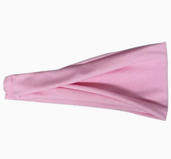 A wide, plain baby-pink fabric headband with a folded, draped design.
