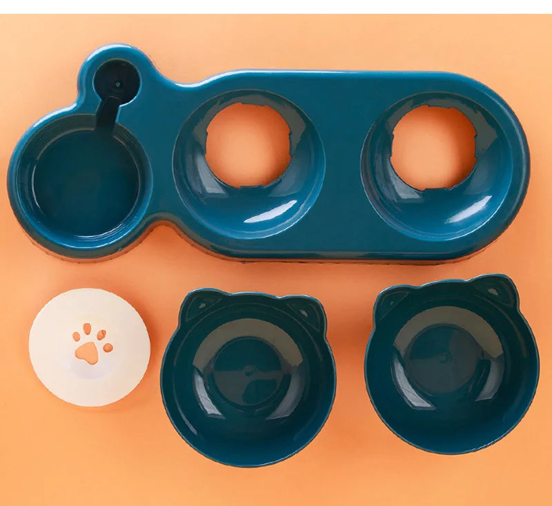 Dark teal pet feeding station with two detachable cat-ear bowls and a white paw-print water bottle accessory.