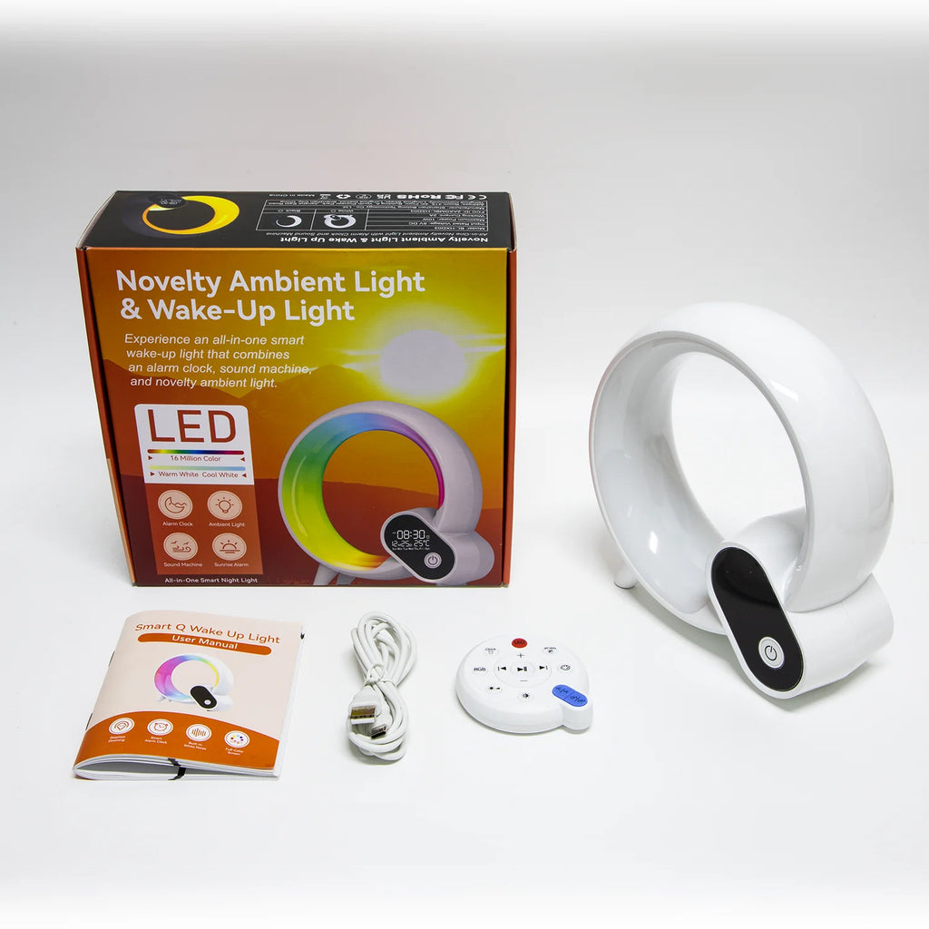 White LED circular wake-up light with digital display, remote control, charging cable, and user manual in its box.