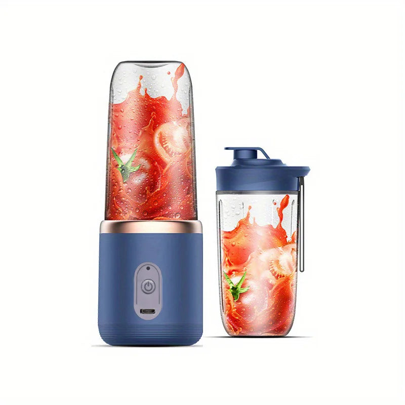 Portable blue electric blender with a gold rim and a travel cup, both filled with blended tomato juice.