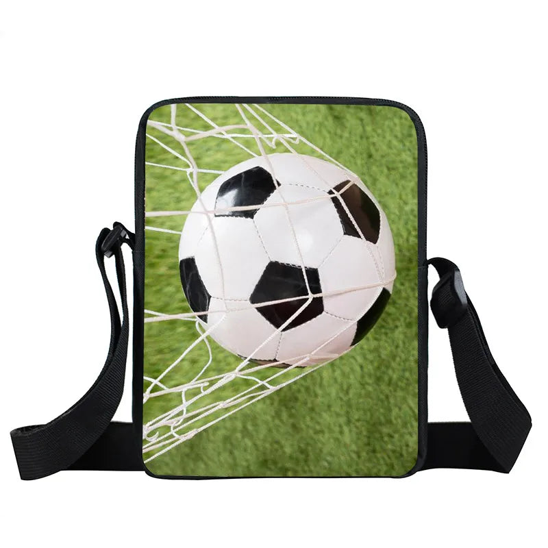 Small black crossbody bag featuring a classic black and white football goal graphic on green grass.