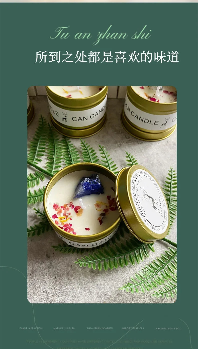 Scented soy candle in a gold tin, topped with dried flower petals and a blue crystal stone. Elegant home fragrance.
