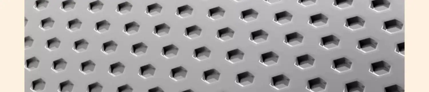Close-up of a grey, heavy-duty cat litter mat featuring a textured hexagonal hole pattern to trap litter.