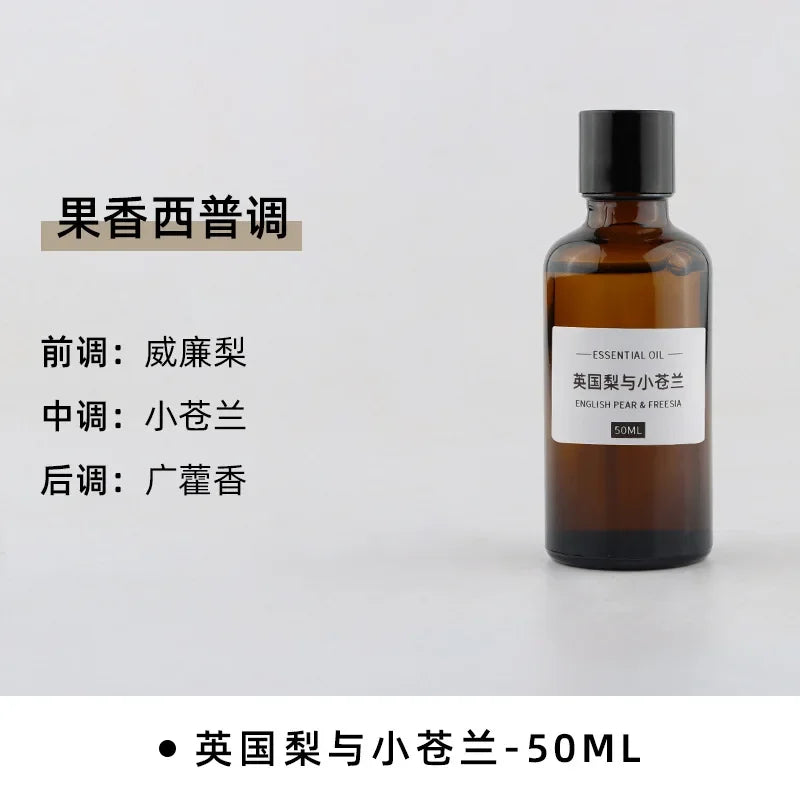 50ml amber glass bottle of English Pear and Freesia essential oil with a black screw cap and minimalist white label.