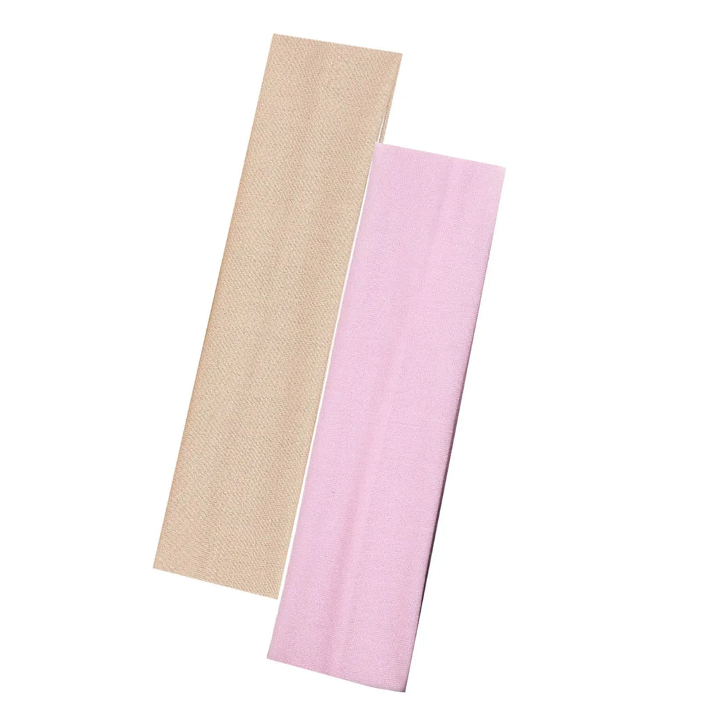 Two wide, plain fabric headbands in nude beige and soft pink.