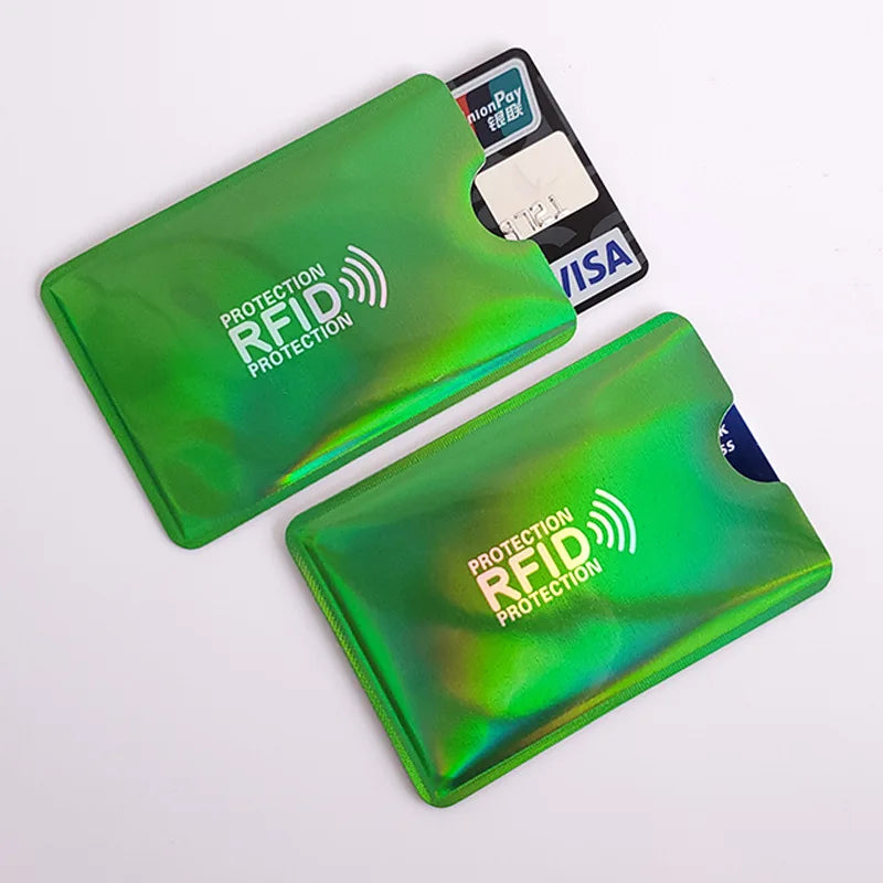 Two metallic green RFID-blocking sleeves for credit cards on a white background.