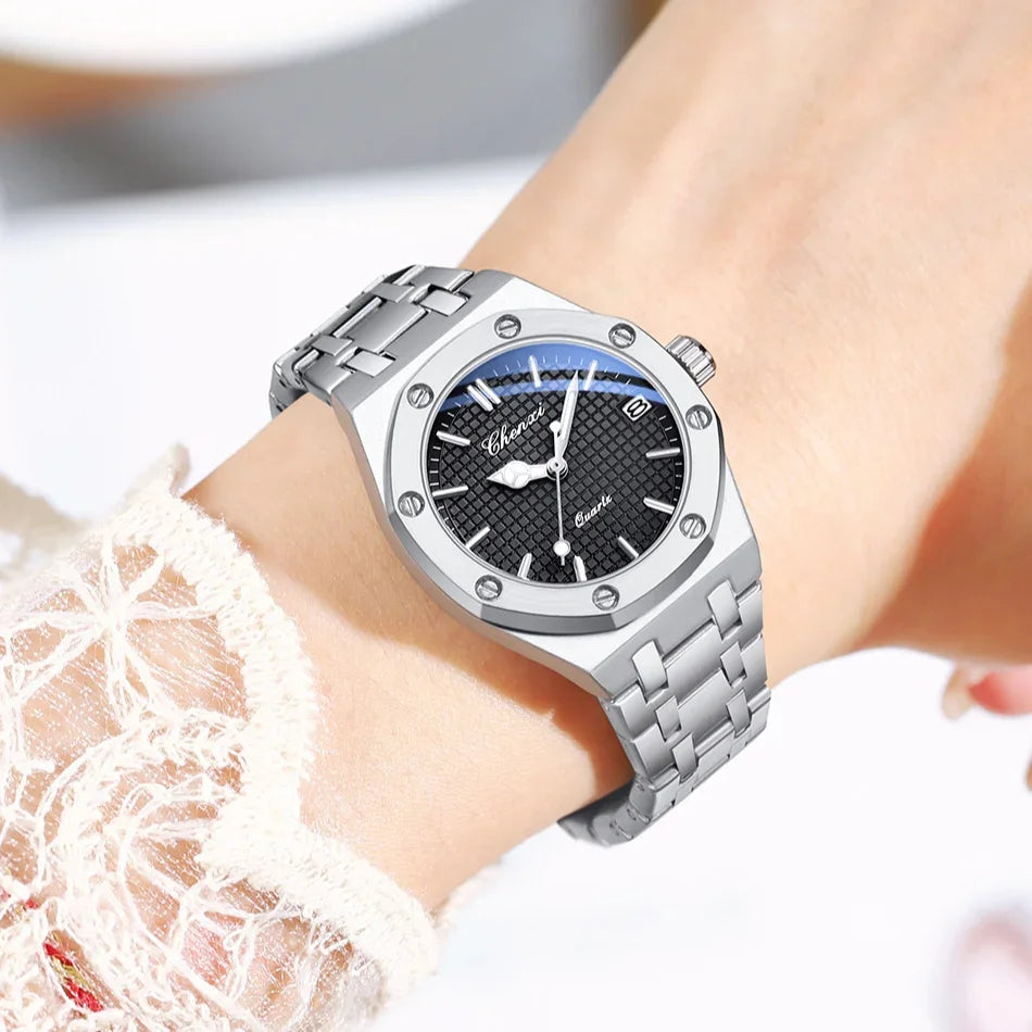 Luxury silver stainless steel analogue watch for women, featuring a black textured dial and a polished metal link strap.