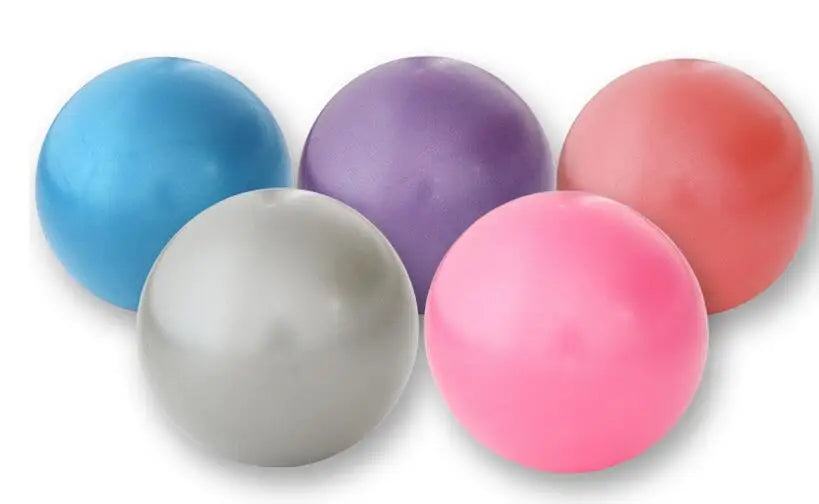Five small fitness balls in blue, purple, red, silver, and pink against a white background.