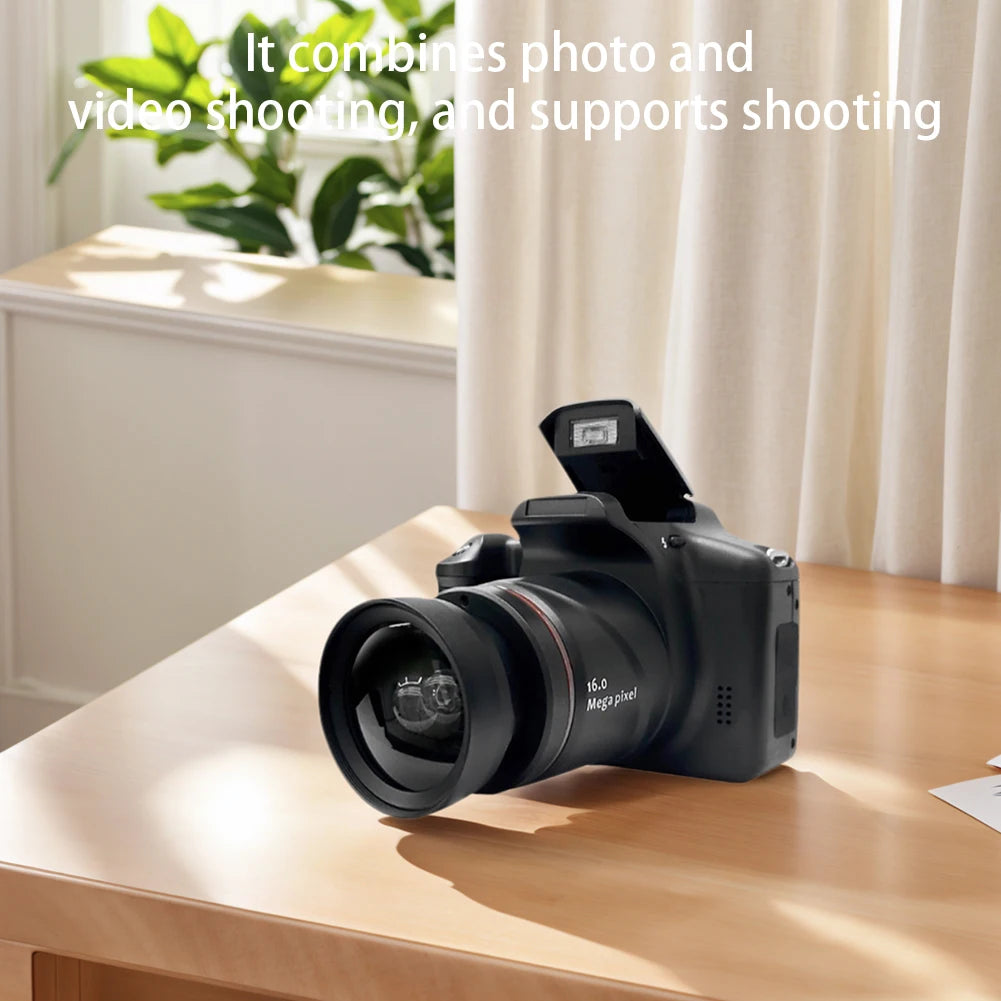 Black 16-megapixel digital camera with a built-in pop-up flash, sitting on a wooden desk.