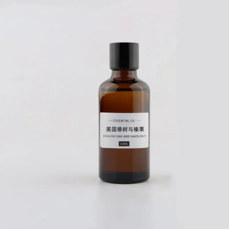 50ml amber glass bottle of English Oak and Hazelnut essential oil with a black screw cap and minimalist label.
