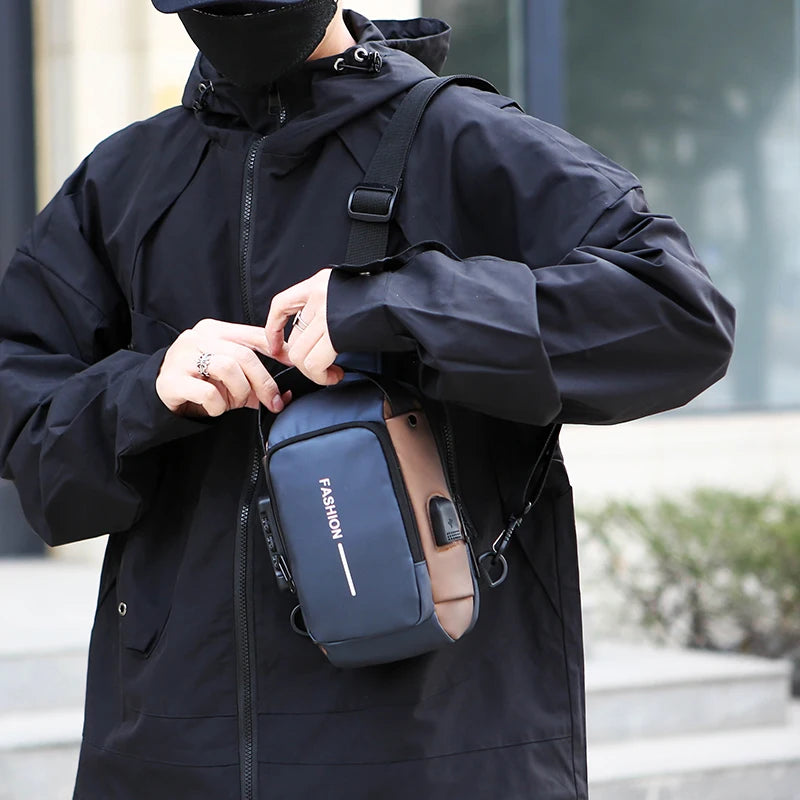 Blue and brown anti-theft crossbody chest bag with an external USB charging port, worn by a person in a black jacket.