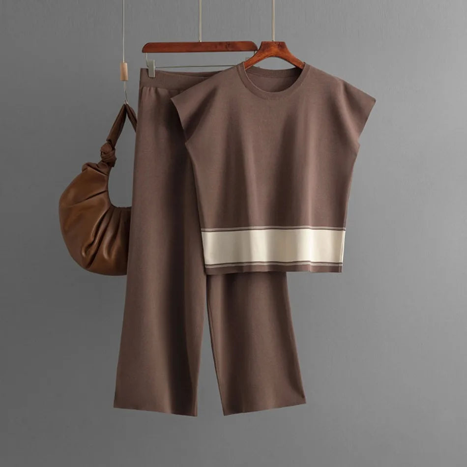 Brown two-piece knit set featuring a cap-sleeve top with a cream hem stripe and matching wide-leg trousers.