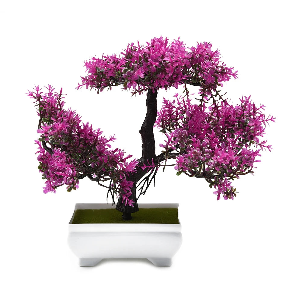Artificial bonsai tree with vibrant magenta leaves, black trunk, and a white rectangular pot on a white background.