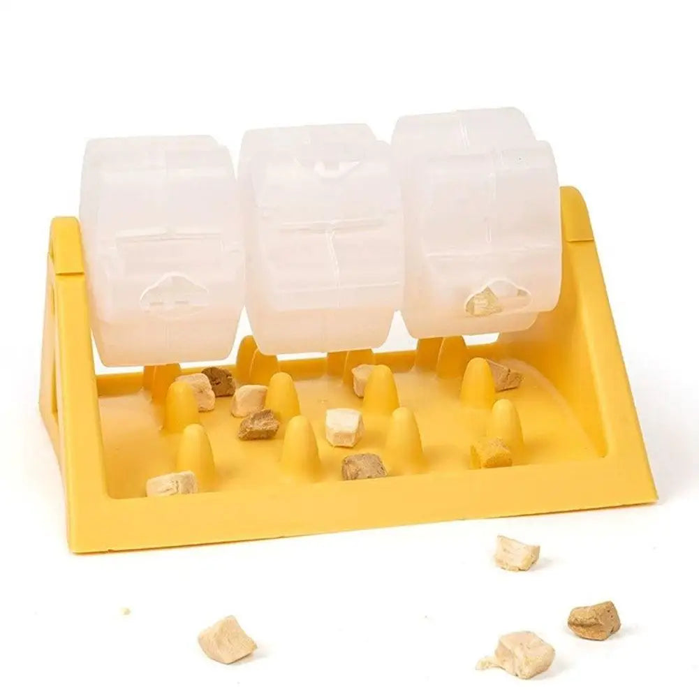 Interactive yellow dog puzzle feeder with three clear spinning treat dispensers and a textured base.
