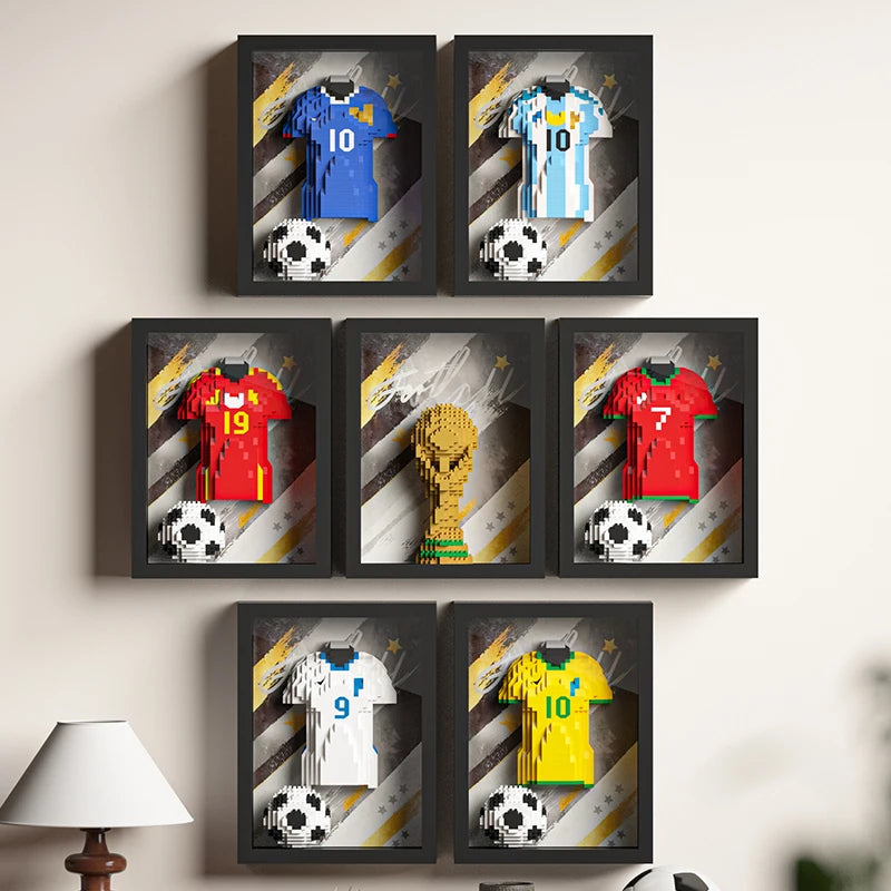 Set of seven framed 3D block-art wall displays featuring various colourful football jerseys and a trophy with balls.