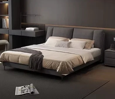 Modern dark grey upholstered double bed with a cushioned headboard and integrated storage in a contemporary bedroom.