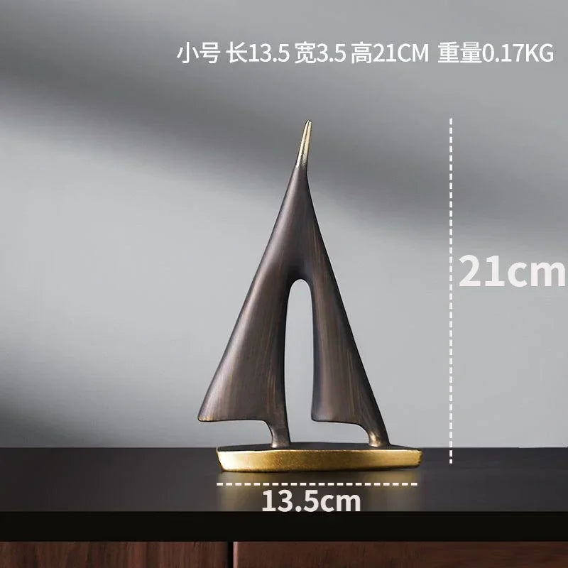 Modern abstract resin sailboat ornament with a metallic bronze finish and a sleek gold-tone base.