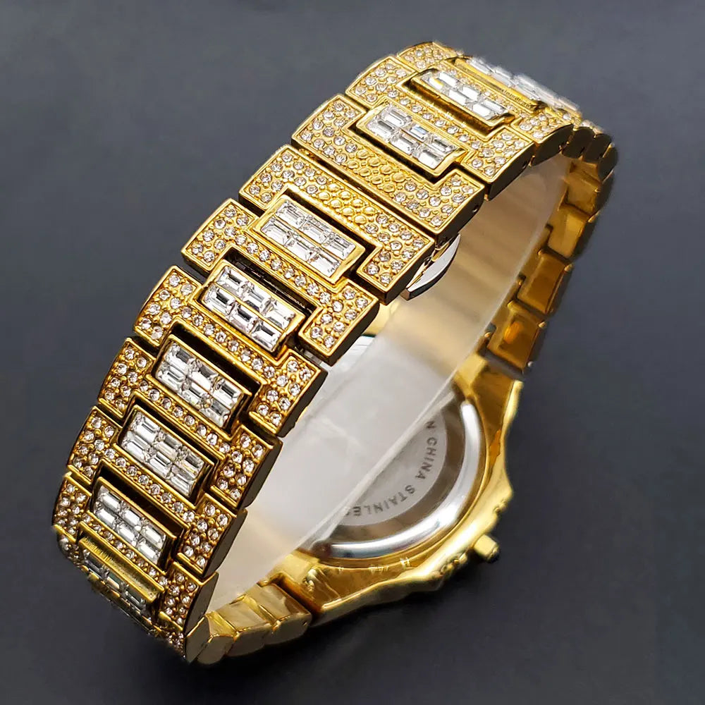 Gold-plated iced-out quartz wristwatch with baguette and round cubic zirconia stones on the bracelet.