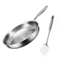 A stainless steel frying pan with a honeycomb textured interior and a matching slotted spatula on a white background.