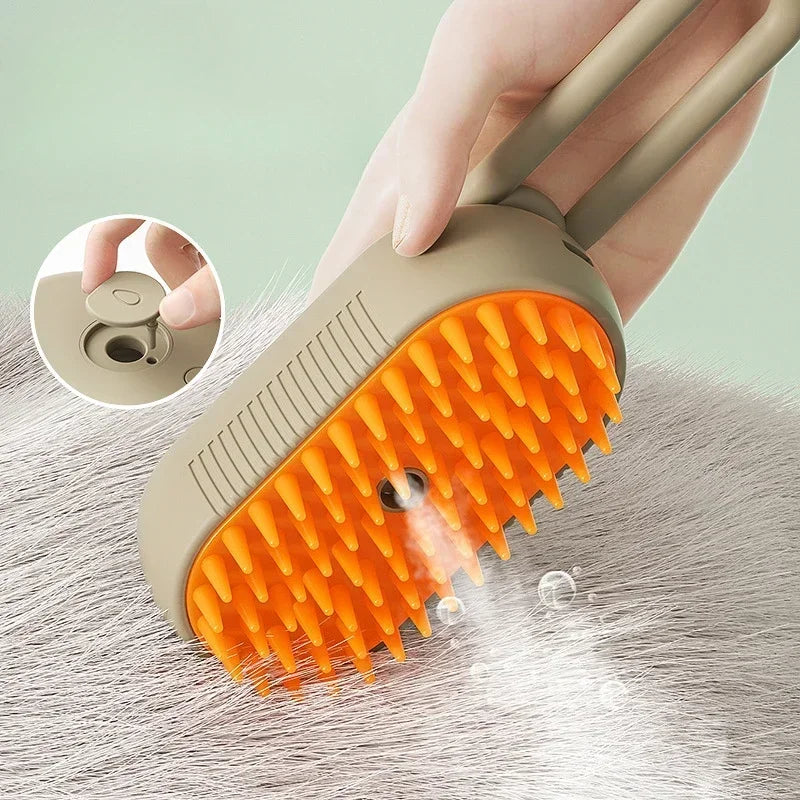 Beige and orange pet steam brush with rubber bristles, releasing mist while grooming light-coloured fur.
