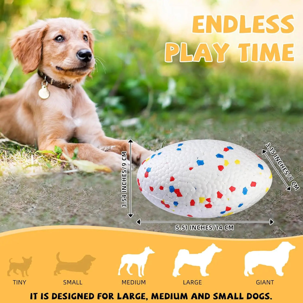 White, textured, oval dog toy with red and blue confetti pattern, shown next to a puppy for scale.