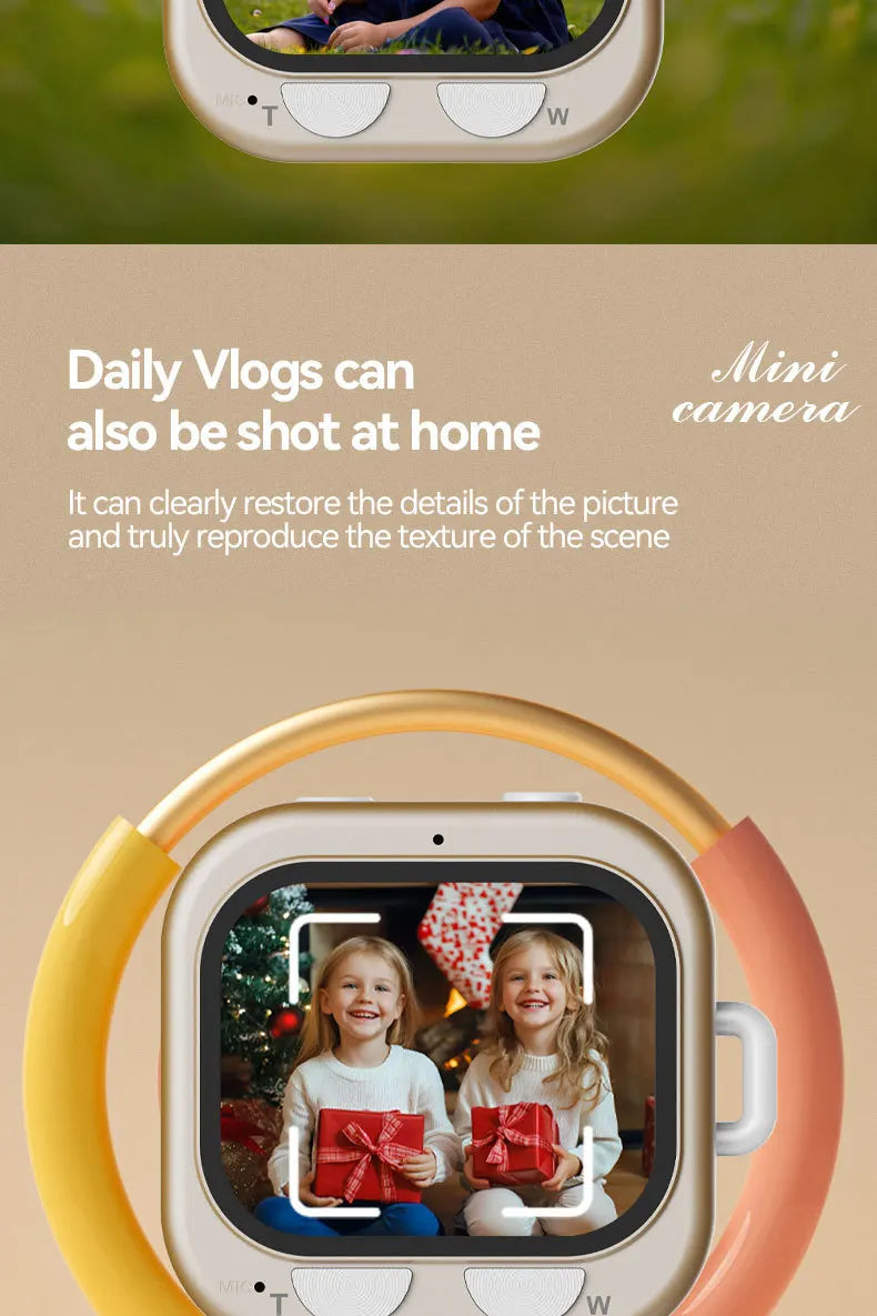Beige plastic digital mini camera with a yellow and orange circular handle and two buttons on the bottom edge.