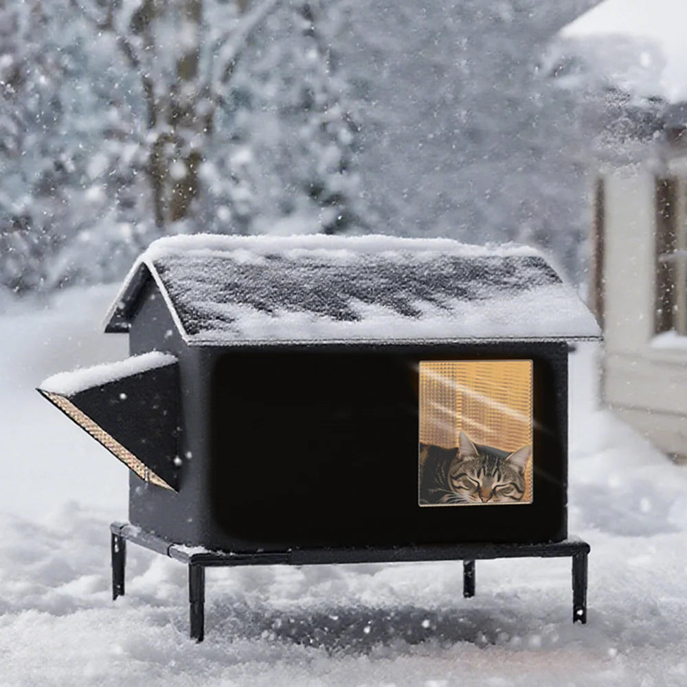 Black waterproof outdoor cat shelter on legs, featuring a roof with snow and a cat sleeping inside a window.