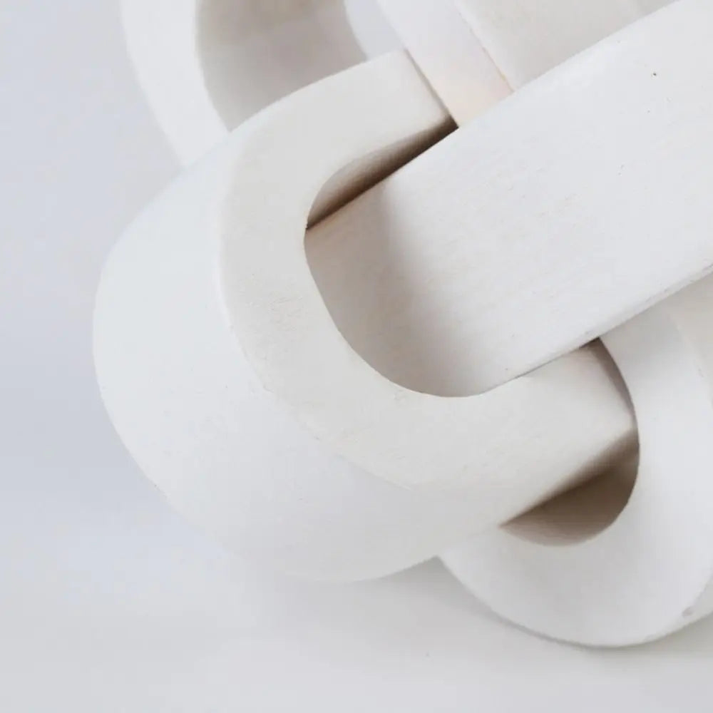 Matte white wooden decorative knot sculpture, featuring an interlocking organic chain design for modern home decor.